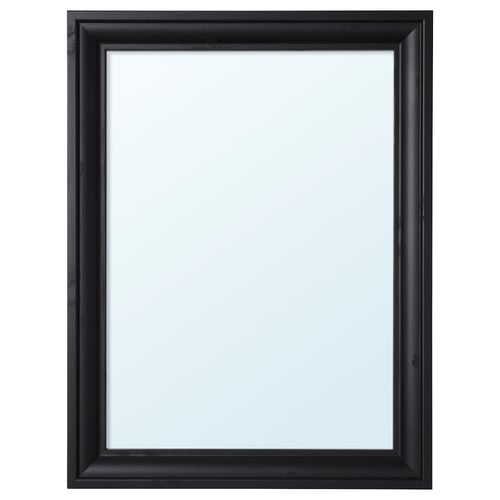 A TOFTBYN mirror. It has a black wooden frame with a classical design. The mirror can be hung vertically or horizontally.