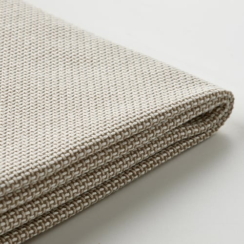 Textured, beige chair cover with woven pattern, neatly folded.
