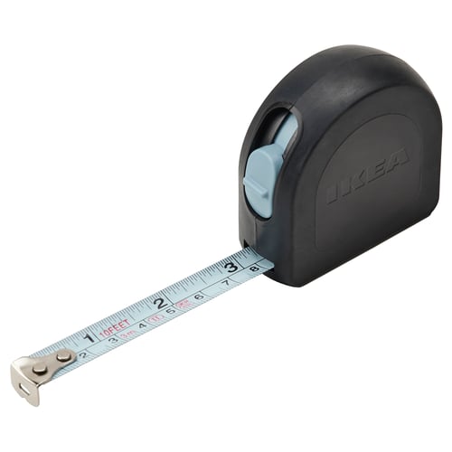 IKEA TRIXIG tape measure, black with grey button, rubberized body, steel measuring tape, precise markings, compact design.
