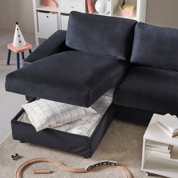 A grey VIMLE sectional sofa with a storage chaise. The seat lift is open, revealing a white and grey chequered lid.