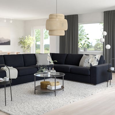 Dark grey VIMLE l-shaped sofa with storage coffee table, pendant lamp, and large windows.