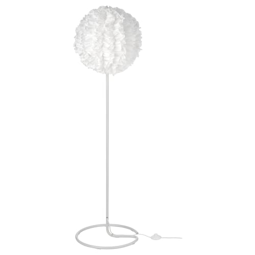 A white VINDKAST floor lamp with a soft, round shade made from recycled polyester, giving off a warm mood light.