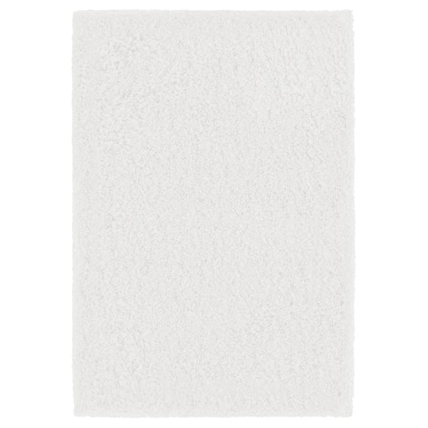 A white ALMTJÄRN bath mat. It is plush and rectangular, made from recycled polyester with a latex backing.