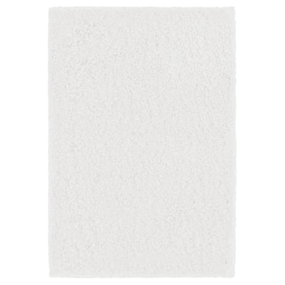 A white ALMTJÄRN bath mat. It is plush and rectangular, made from recycled polyester with a latex backing.