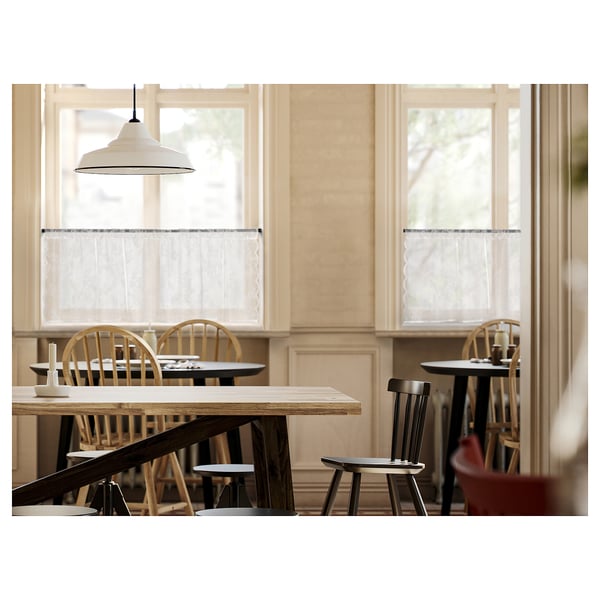 Wooden furniture, pendant light, sheer curtains.