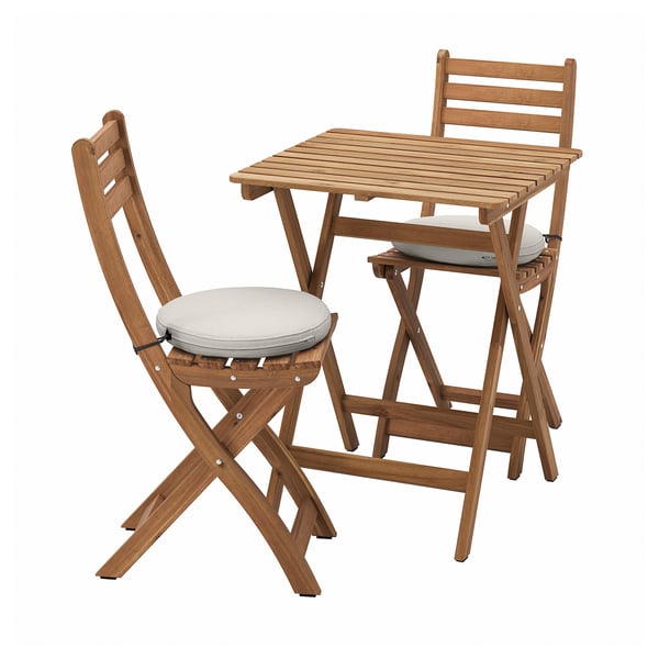 Wooden outdoor dining set with light grey cushions. Contains folding table and two chairs in natural finish. Ideal for small outdoor spaces.