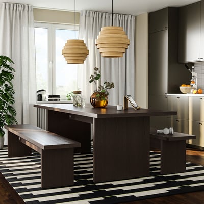 Modern kitchen with dark BERGSHYTTAN bench, pendant lights, and grey curtains.