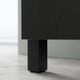 Black BESTÅ furniture leg, hexagon-shaped, on light floor.