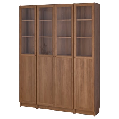 A BILLY bookcase with wooden finish and glass doors, featuring multiple shelves for storage.