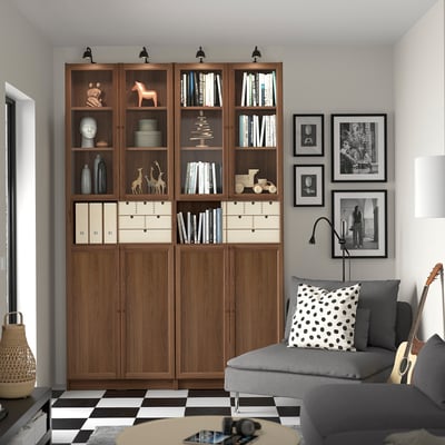Luxury living room with BILLY bookcase, sofa & polka dot pillow, black-and-white photos.