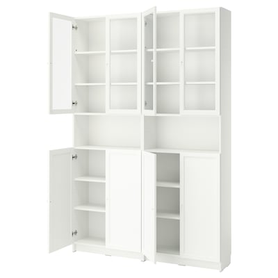 A tall white BILLY bookcase with glass doors and adjustable shelves. It three sections, two with glass doors and one solid.