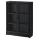 A black BILLY bookcase with glass doors. The rectangular shape has adjustable shelves and sturdy design with modern appeal.
