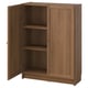 A BILLY bookcase in walnut colour, featuring two closed doors and adjustable shelves. Its made of wood with a simple, rectangular design.