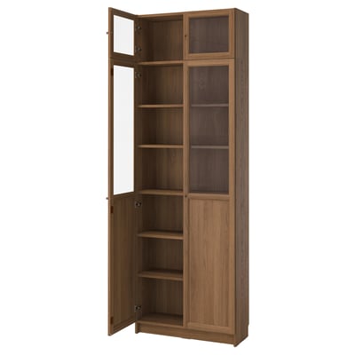 An empty wooden tall bookcase with glass doors.
