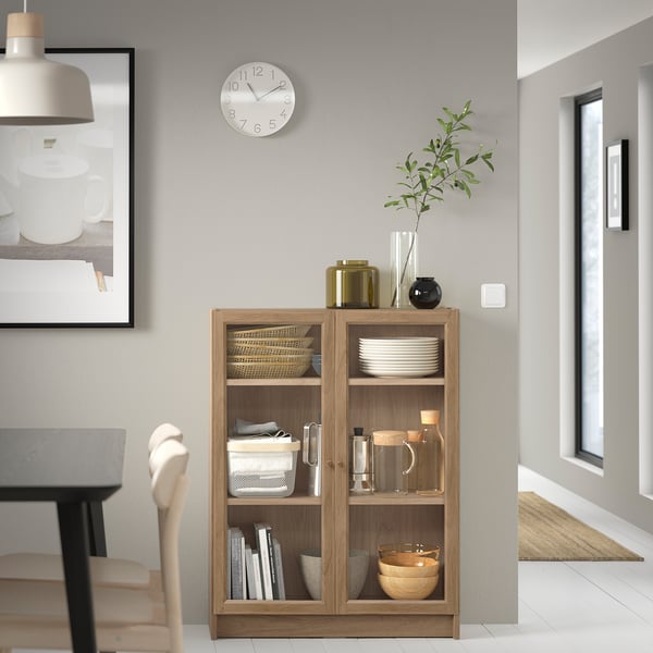Modern living room with wooden BILLY bookcase, grey walls, chair, and decor.