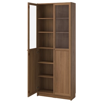 BILLY: wooden bookcase, adjustable shelves, glass-paneled doors, warm brown colour.