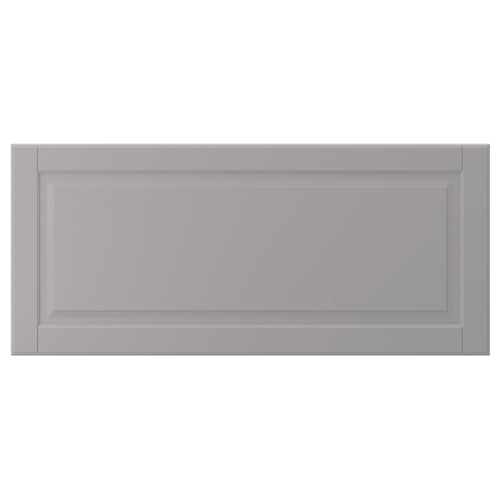 A grey, rectangular BODBYN cabinet door with bevelled panels, made of fibreboard.
