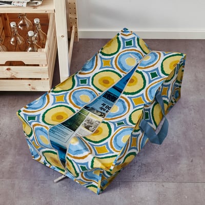 Colourful geometric-patterned EKAÅN bag on floor, large and upright with handles and zip.