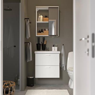 Modern, compact white bathroom unit with mirror cabinet. Includes vanity, bowl, & hooks. Clean, minimalist design.