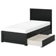 Black FÅGELFJÄLLET bed with open storage drawer, sleek dark wooden design, white mattress.