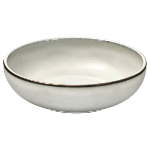 A GLADELIG ceramic dish. Its round, white with a sandy glaze, and made of stoneware. The bowl shape is deep and elegant, perfect for serving.
