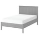 A grey GULLABERG bed frame with a white mattress. Vertical grooves on the high headboard. Robust grey legs and wooden slats for support.