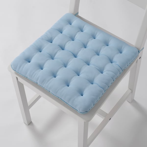 Blue chair pad with tufted design on white chair, providing comfort and coolness.