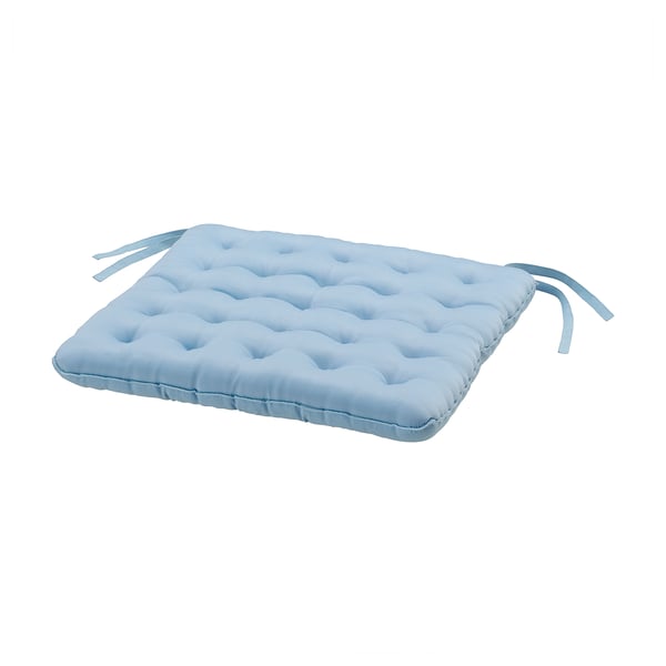 Light blue rectangular seat cushion with tufted design & ties for securing.