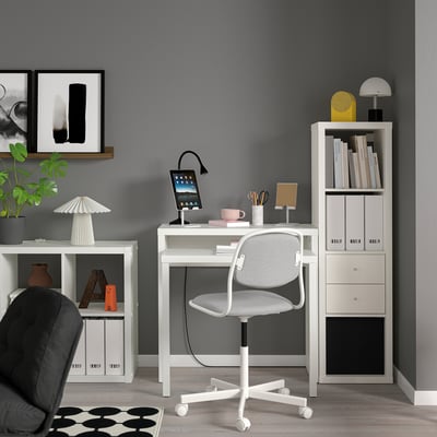 White LÄNGDHOPP space-saving desk with chair, tablet holder, and lamp for small areas.