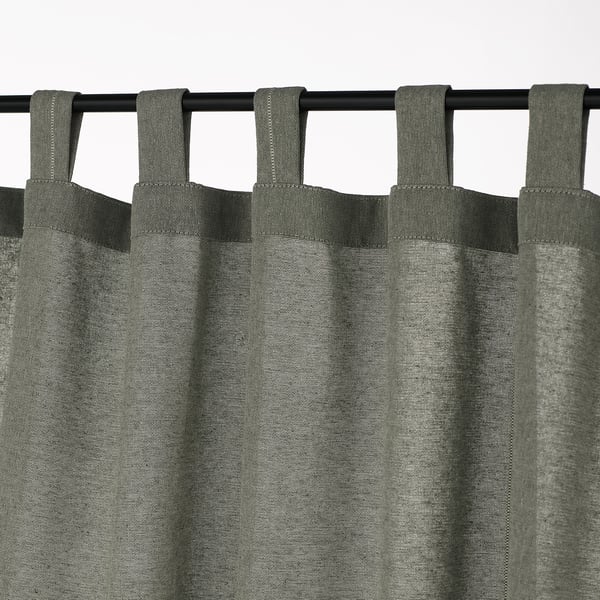Curtain with tab tops, featuring loops for easy hanging, providing light control and privacy.