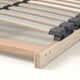 Close-up of wooden slatted bed base with grey supports, showcasing sturdy, layered plywood design for durability and ventilation.