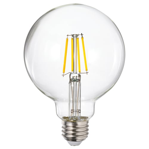 A round light bulb named LUNNOM with yellow filaments inside a glass cover.