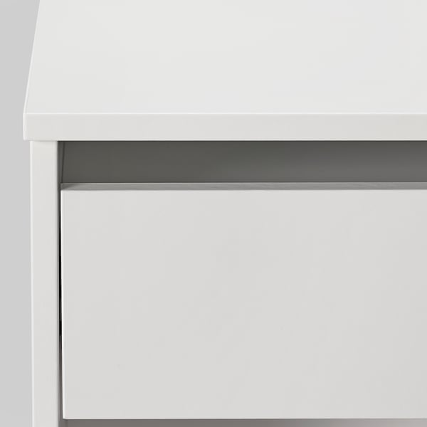 Modern white dressing table with smooth surfaces and sleek design.