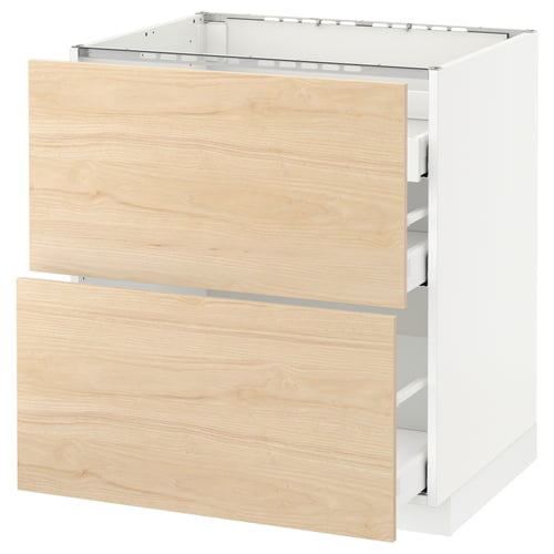 Displays a modern white kitchen cabinet with light ash wood drawers and a sturdy frame, part of the METOD kitchen system.