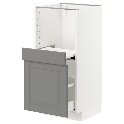 A white and grey METOD kitchen cabinet with a smooth-running drawer and pull-out shelf, featuring a traditional design with a warm feel.