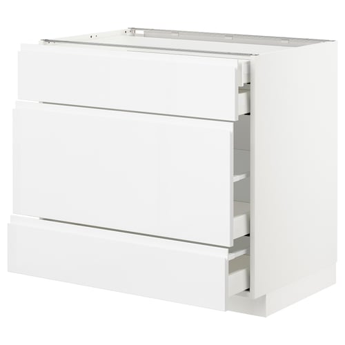 White modern kitchen cabinet with shiny finish and sleek drawers.