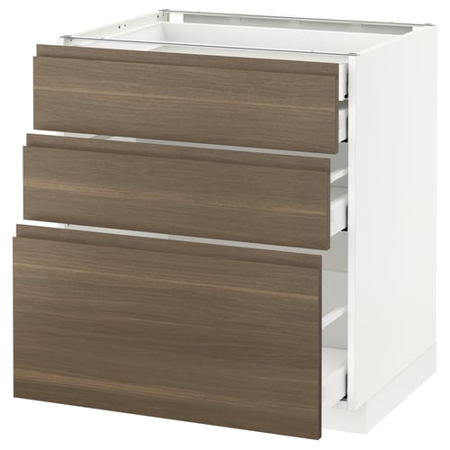A white METOD kitchen cabinet with three dark walnut drawers. It a minimalist design with integrated handles.