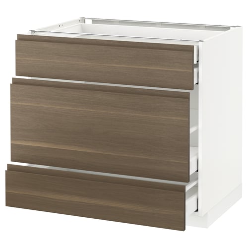 A modern kitchen cabinet from the METOD system by IKEA. It has three dark walnut drawers with sleek, minimalist handles and a clean white frame.