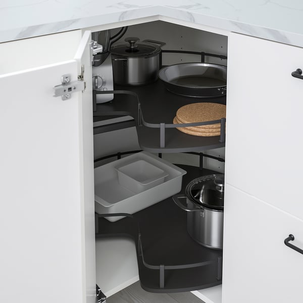 Open METOD kitchen cabinet showing organised storage with pots, pans, and trays in a corner unit.