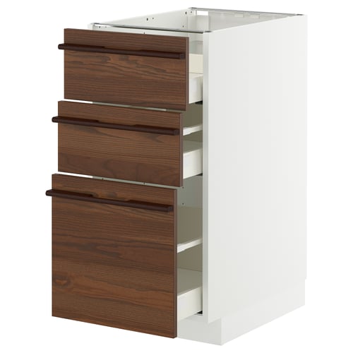 A white METOD kitchen cabinet with dark brown stained ash veneer drawers featuring wooden handles.