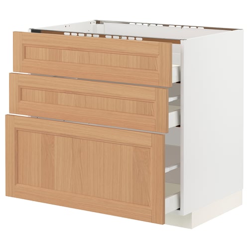 Wooden kitchen cabinet with three drawers. Light brown oak finish. Full-extension drawers with soft-close feature.