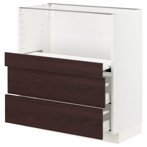 A white METOD kitchen cabinet with dark brown askersund drawers. The cabinet has a sleek, modern design with smooth-running drawers.
