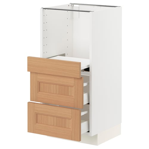 Modern white kitchen unit with oak drawer fronts. Multiple drawers and shelves. Part of IKEAs METOD system.