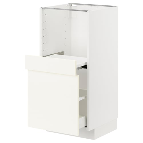 White ikea METOD kitchen cabinet with one open drawer.