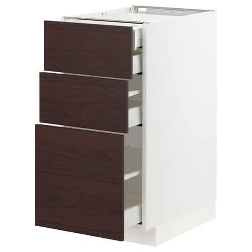 White ikea METOD kitchen cabinet with three dark brown drawers.