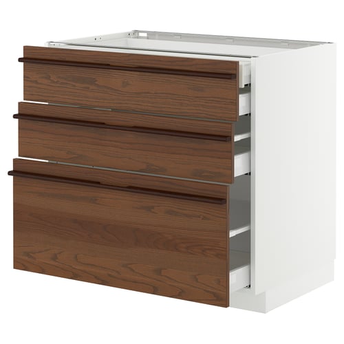 A dark brown wooden drawer unit from IKEAs METOD kitchen system. It three pull-out drawers with a sleek white frame.
