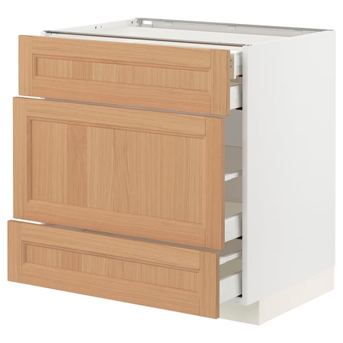 An open METOD kitchen cabinet with wooden drawers in natural oak.