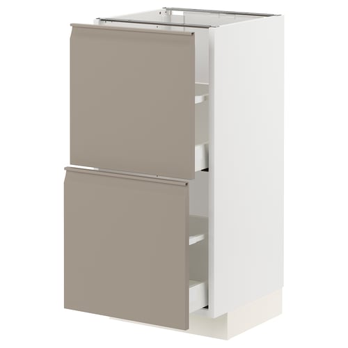 An ikea METOD kitchen cabinet in white with grey-beige drawers.