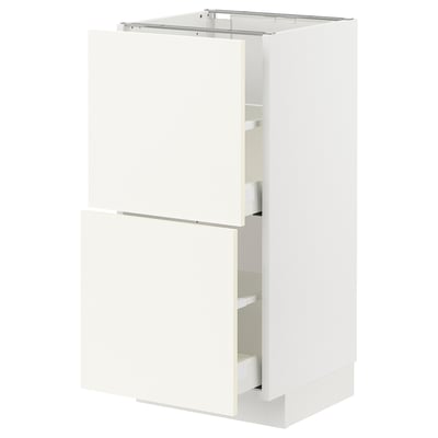 A white METOD kitchen cabinet with two drawers and a door. Its sleek, modern, and well-organized.