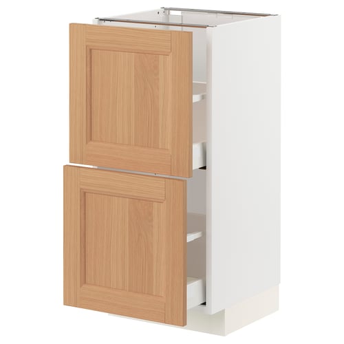 A METOD kitchen cabinet with natural oak drawers and white sides. It two large drawers and a shelf inside.